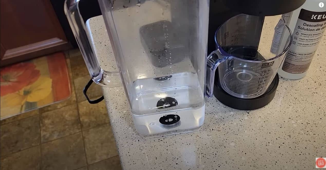 keurig water tank and machine with glass measuring cup

