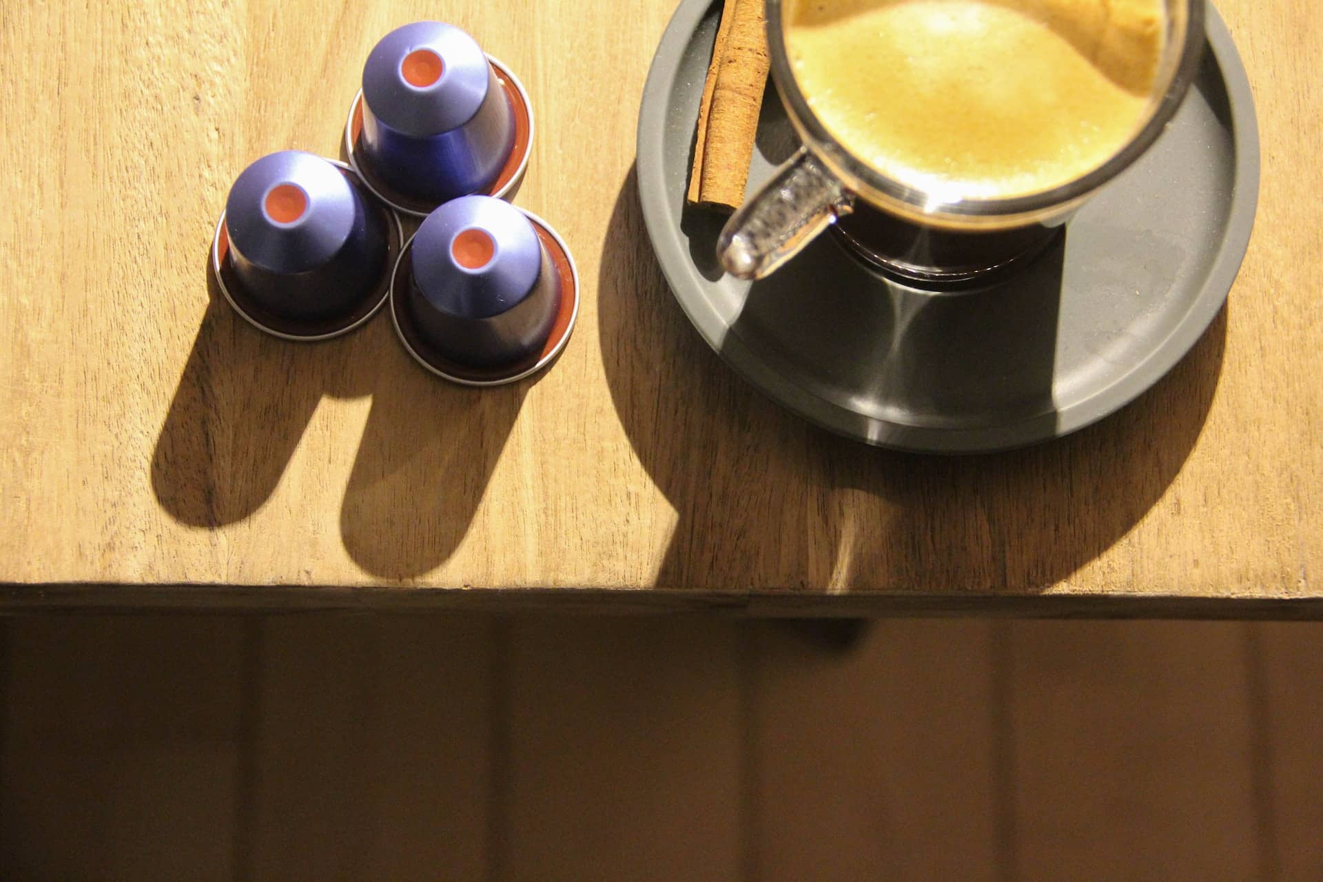 Nespresso pods next to a cup of coffee