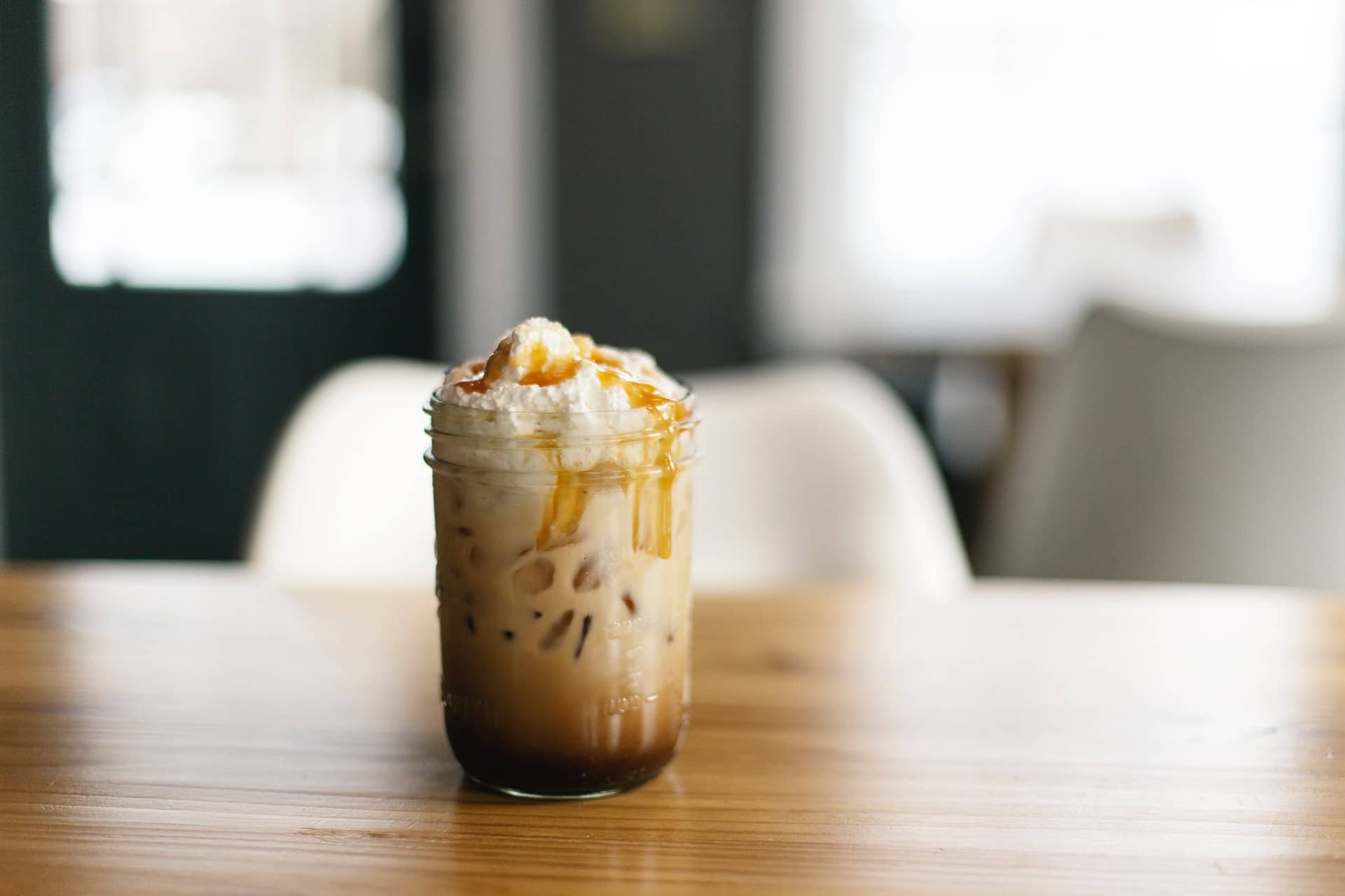 iced coffee in glass with whipped cream