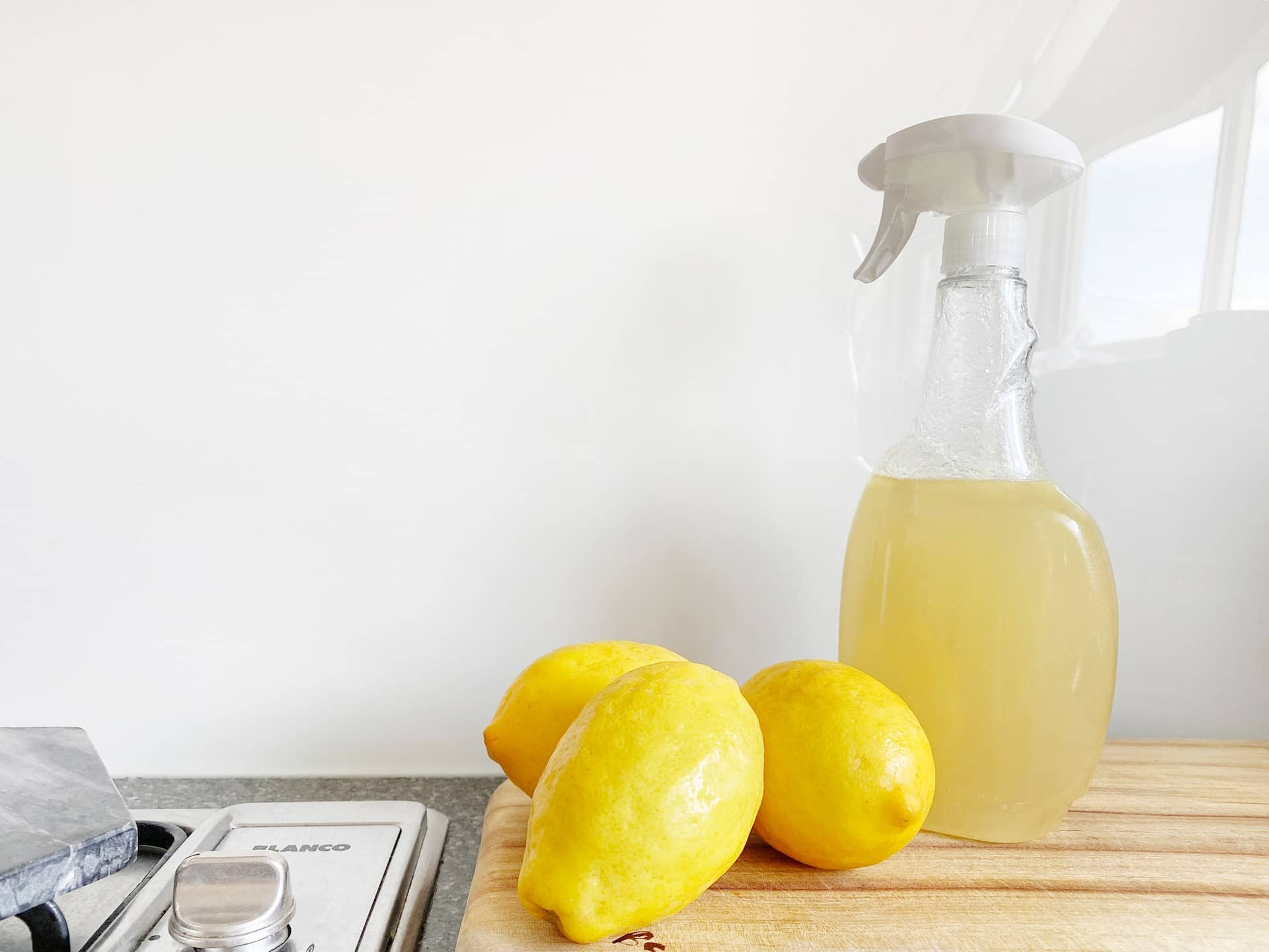 lemons next to a bottle of vinegar