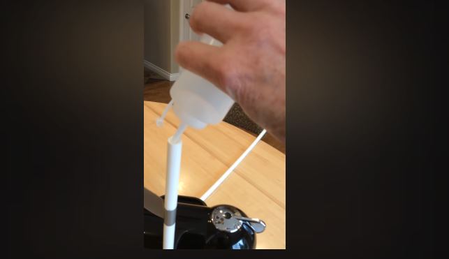 water poured into flexible tubing nespresso