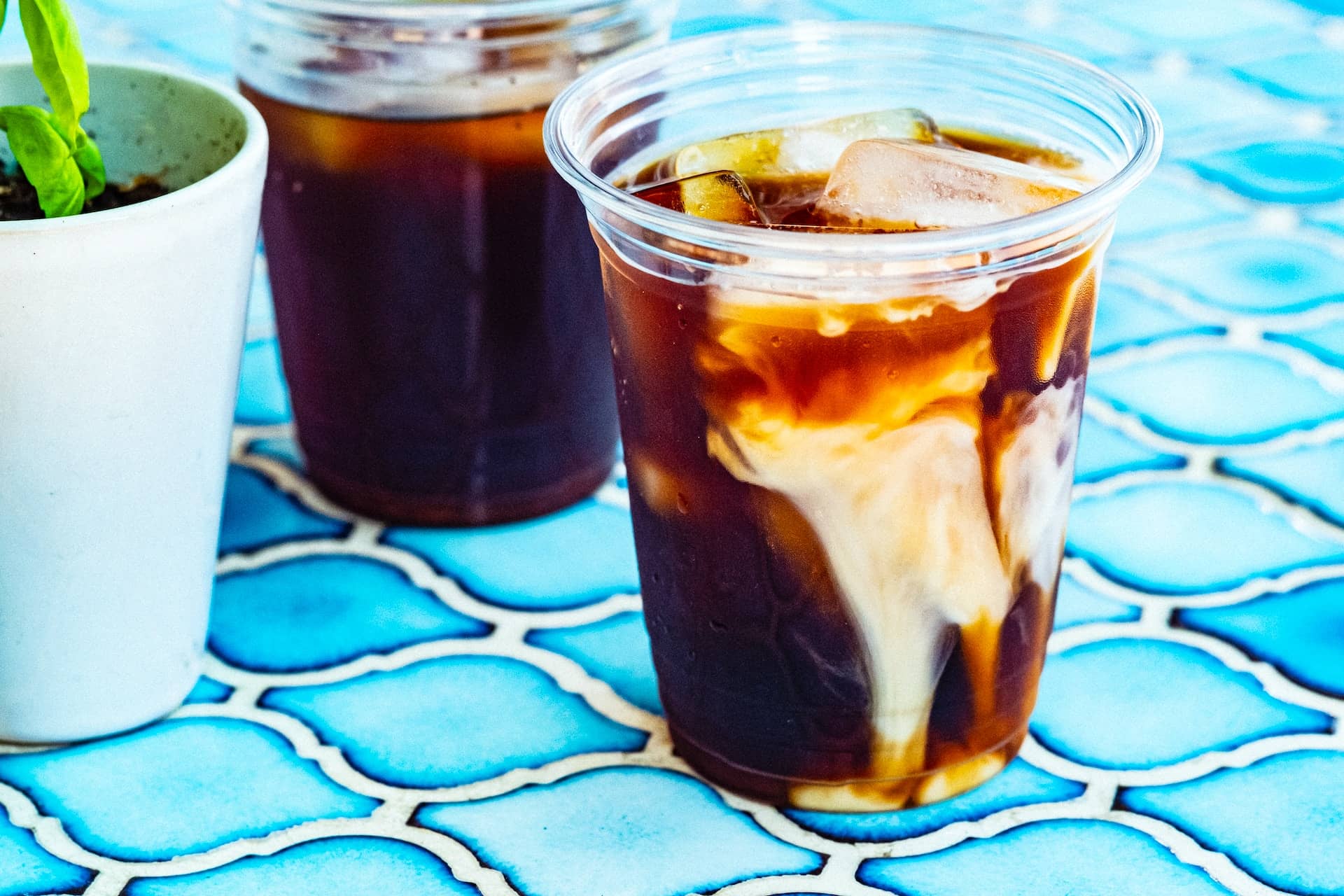 iced coffee with milk in plastic cup 