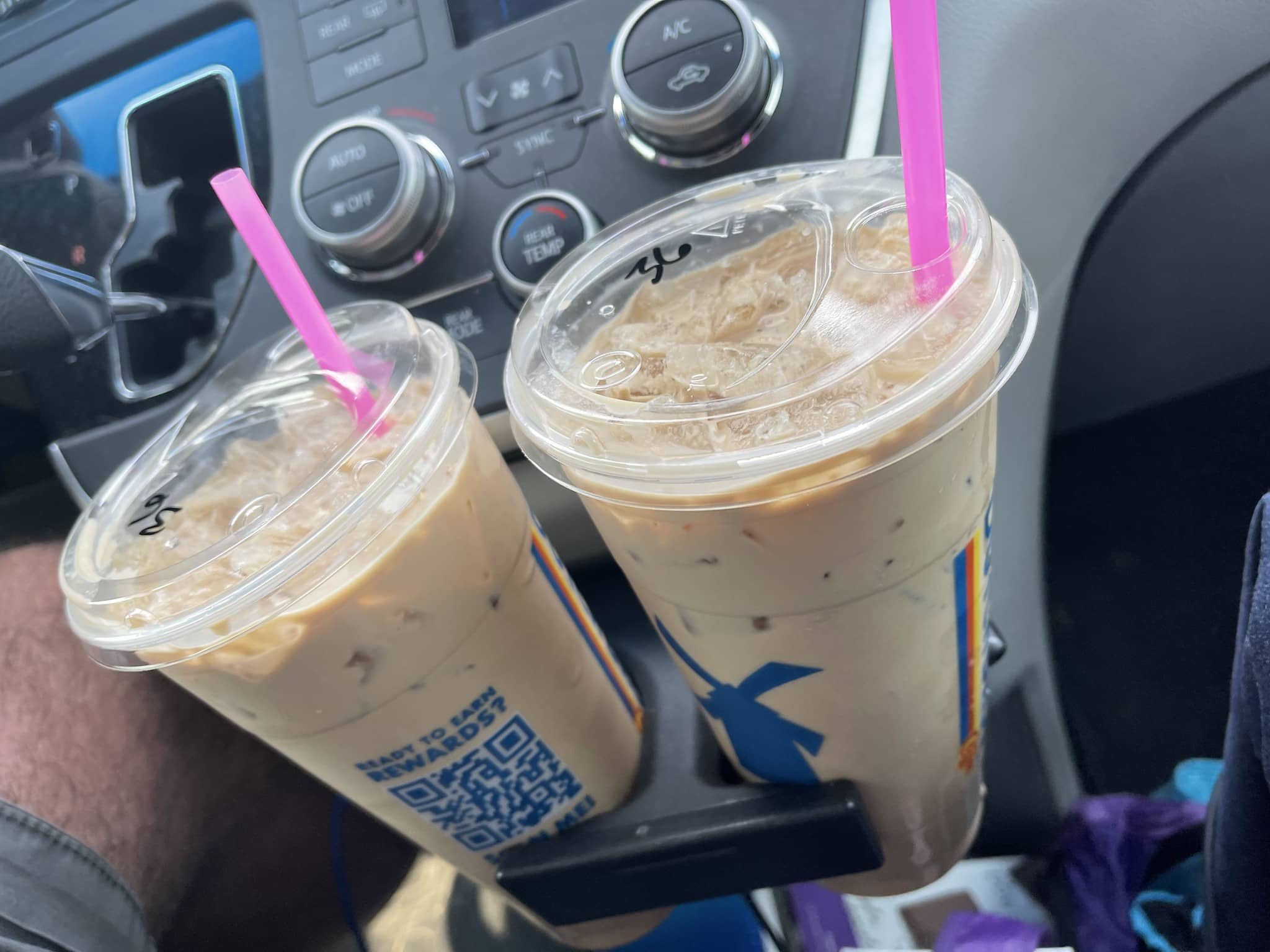 2 iced dutch bros drinks in a cupholder