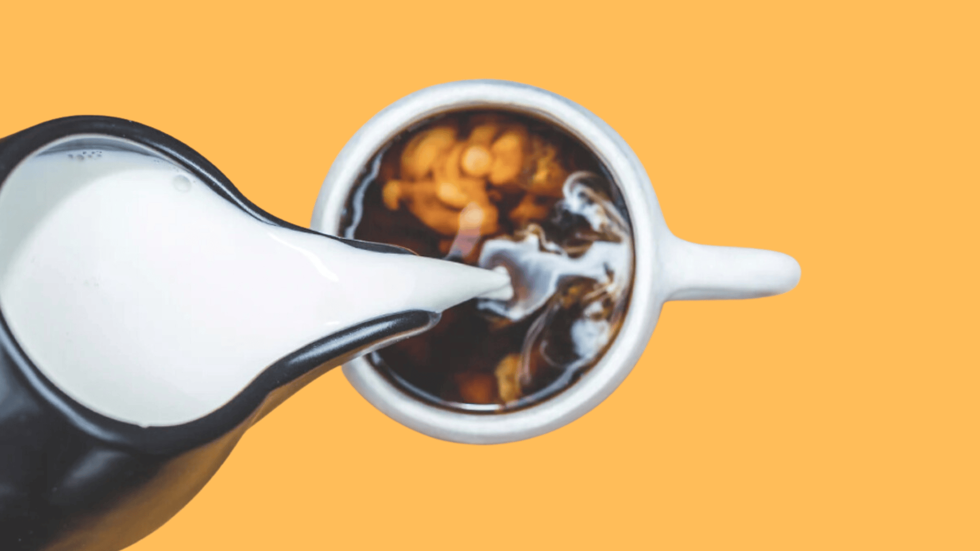 creamer pouring into coffee mug