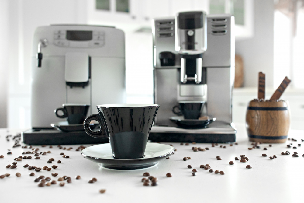 Cup and saucer in front of 2 coffee brewing devices